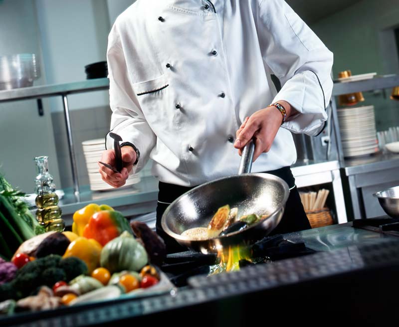 chef-with-pan-on-stove