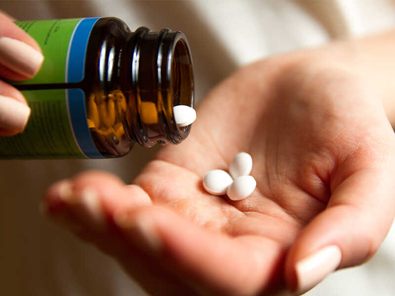 A,Young,Woman,Pours,The,Pills,Out,Of,The,Bottle